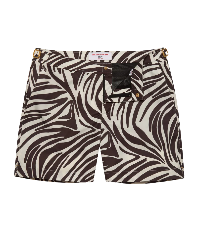Front view of the Orlebar Brown Bulldog Golden Gun Zebra Swim Shorts in Truffle Latte, featuring an exclusive zebra print and gold-tone ‘007’ side adjusters for a tailored, adjustable fit.