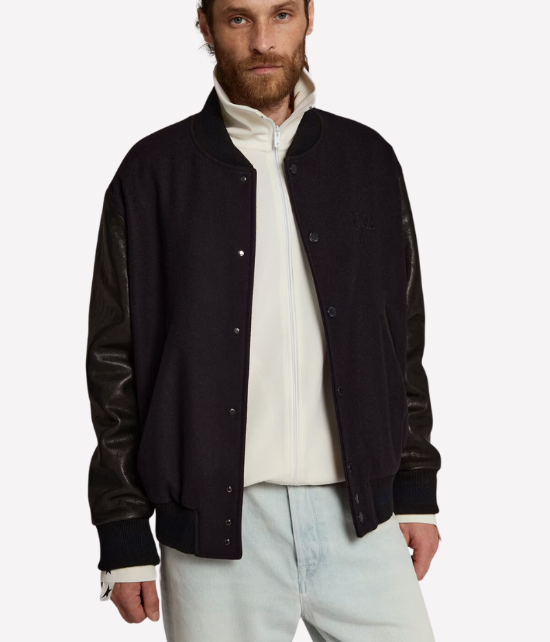 Golden Goose Golden Leather Bomber jacket in dark blue and black, featuring a wool blend body with distressed black leather sleeves and a signature double gold star detail on the back. Regular fit with button-up front, front pockets, and cotton lining for comfort. Crafted in Italy for a laid-back luxury look.