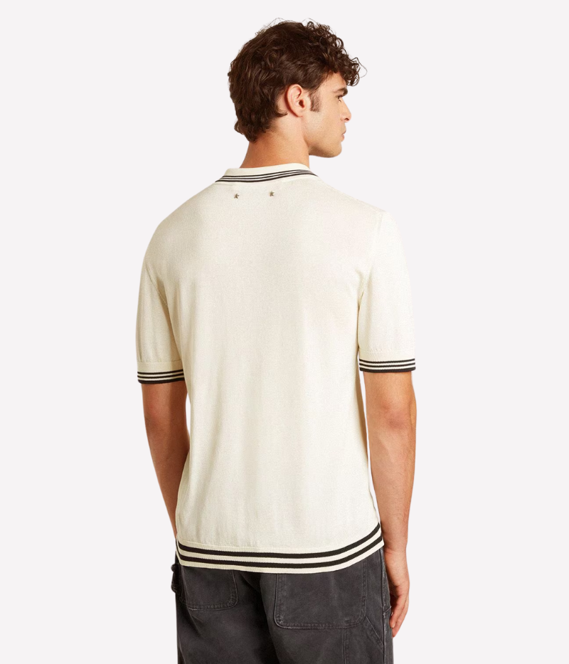 Golden Goose Journey Polo Shirt in worn white, crafted from soft knitted cotton-viscose with dark blue ribbing. Features a front pocket, mother-of-pearl buttons, and the signature double star on the back. Made in Italy.