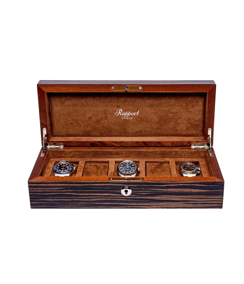 Rapport London Heritage Five watch box with a Macassar finish, gold-plated hinges, lock and key, adjustable suede-lined cushions, and a glossy high finish. Designed to hold five watches.
