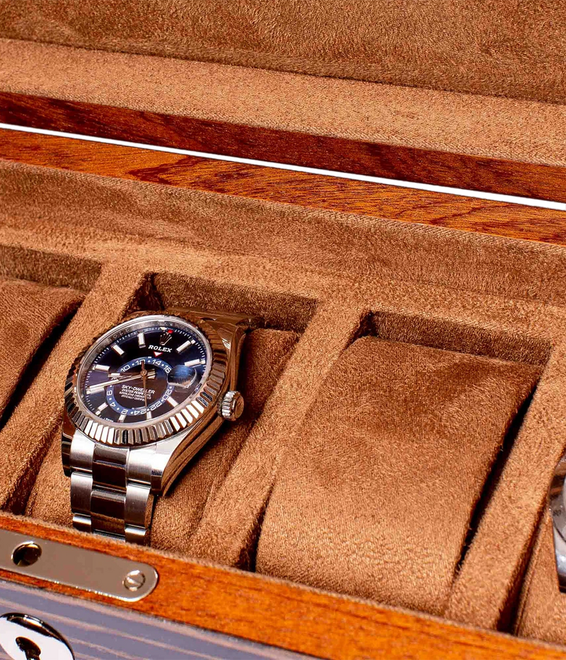 Rapport London Heritage Five watch box with a Macassar finish, gold-plated hinges, lock and key, adjustable suede-lined cushions, and a glossy high finish. Designed to hold five watches.