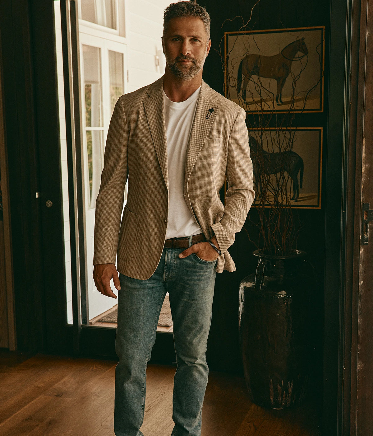 Model wearing the Lardini Man Jacket Iconic in 150BE open over a white tee with mid-wash jeans and brown shoes, full-length front view