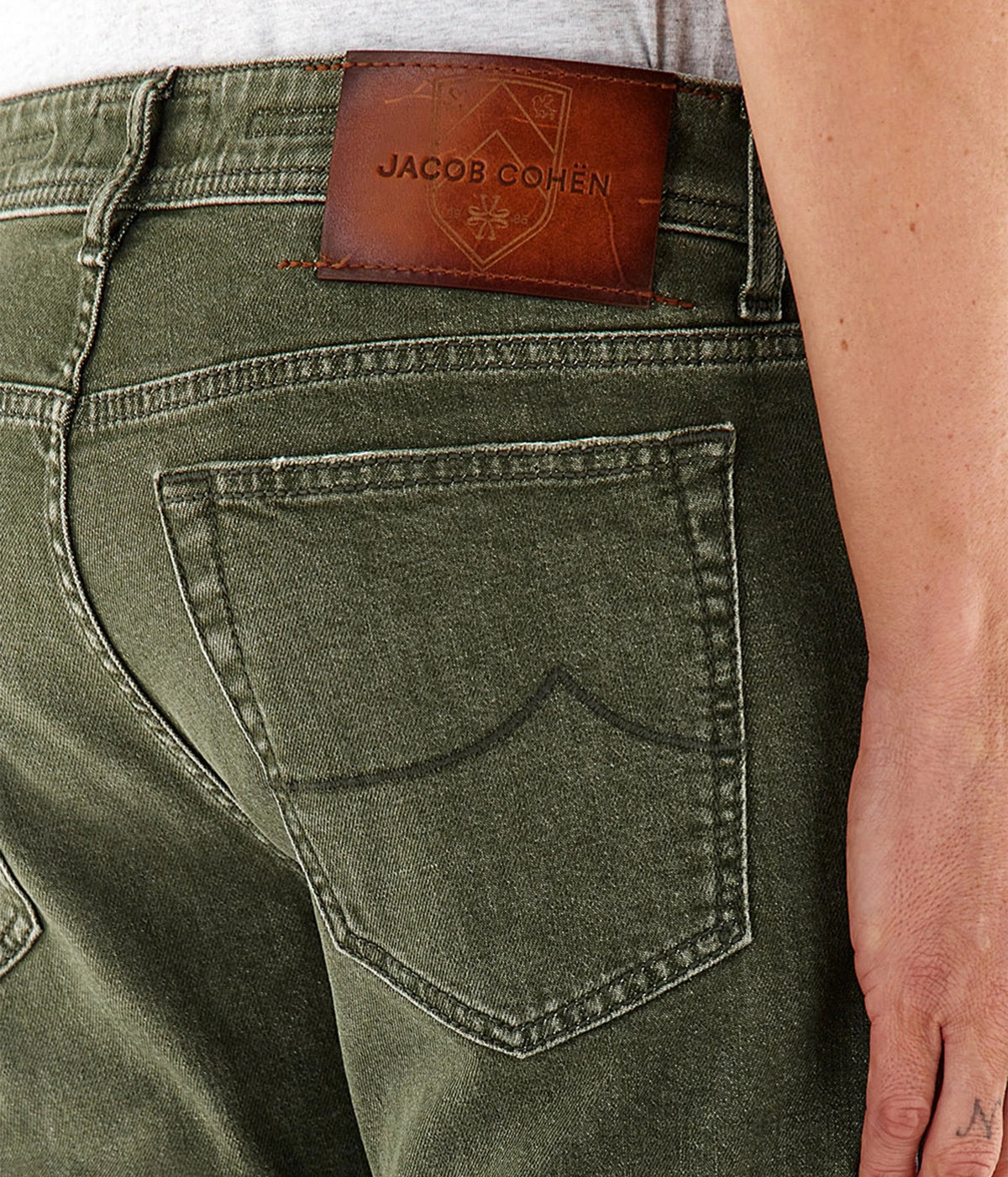 Close-up of Jacob Cohën Bard Regular-Slim Jeans in Vintage Green showing the tan leather patch and back pocket