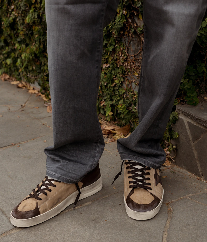 Man wearing Golden Goose Stardan Sneaker in Beige, Brown & White with grey jeans, front view