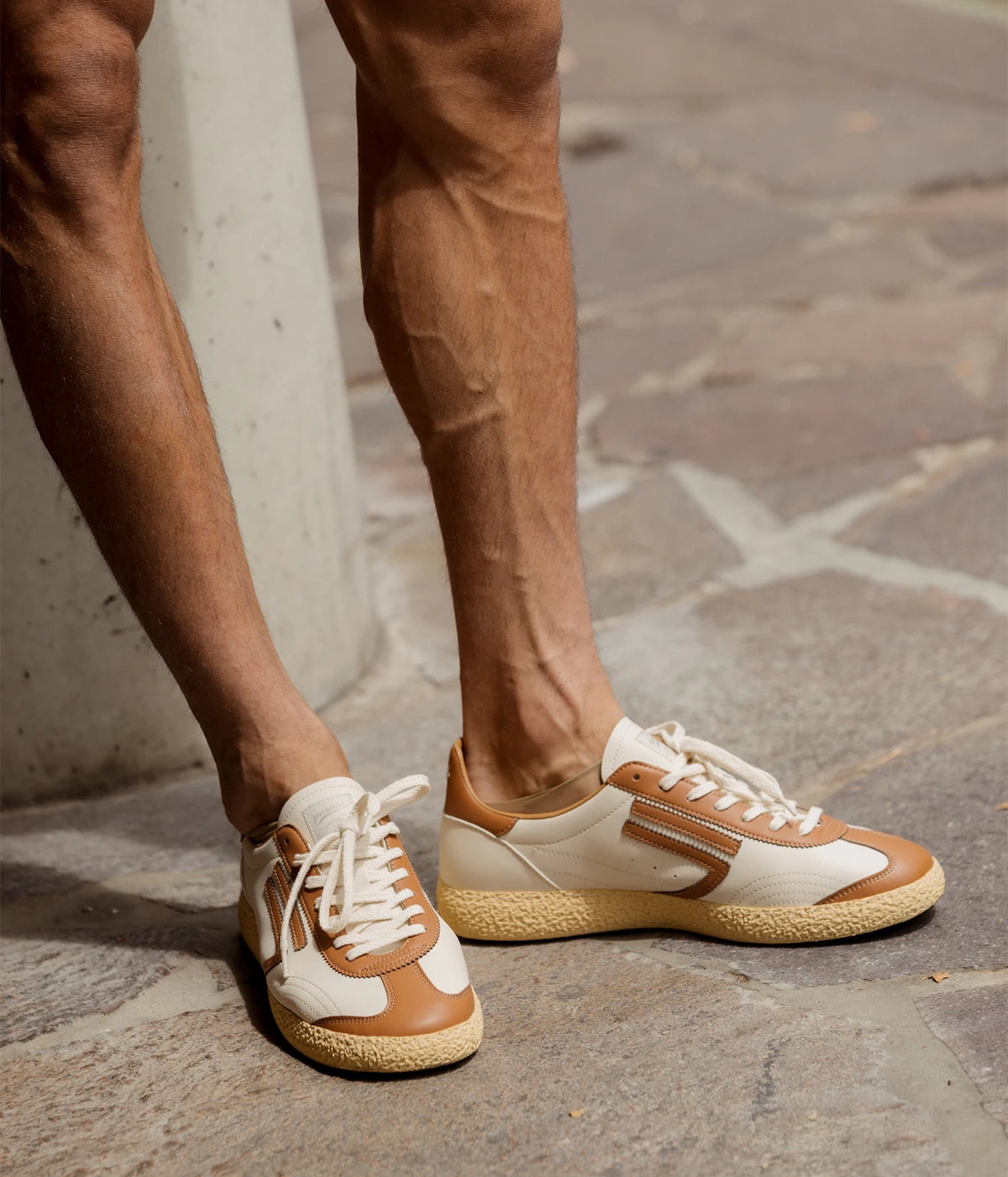 Man wearing Puraai 6.01 XS Sneaker in Hockey on stone paving, side view