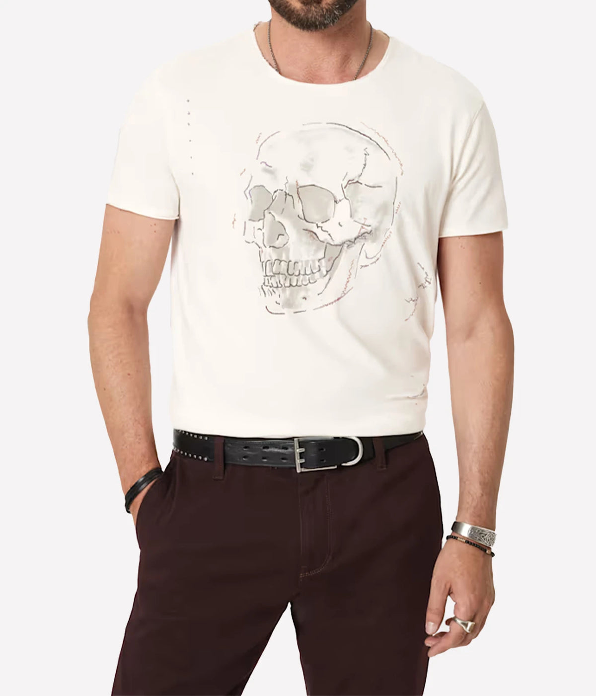 Man wearing John Varvatos Skull Embroidery Raw Edge Tee in Salt with dark brown trousers and a black belt, front view