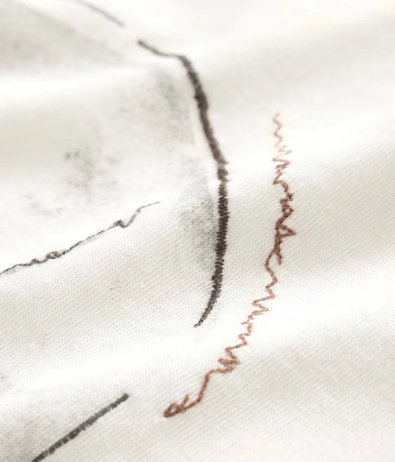 Close-up of John Varvatos Skull Embroidery Raw Edge Tee in Salt showing the embroidery detail