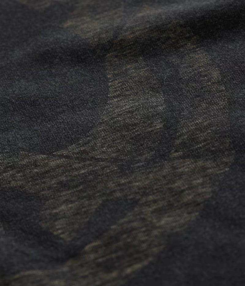 Close-up of John Varvatos Peace Maker Raw Edge Tee in Black showing the reverse-print artwork on the fabric