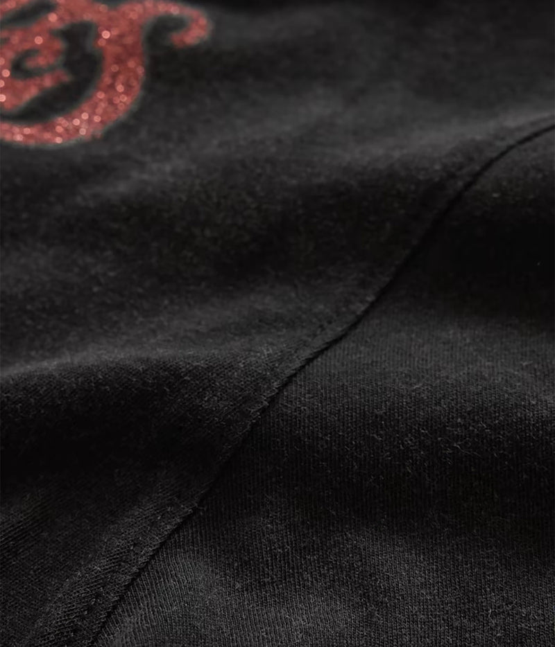 Close-up of John Varvatos The Rolling Stones NYC Raw Edge Tee in Black showing the fabric, seam and red graphic detail