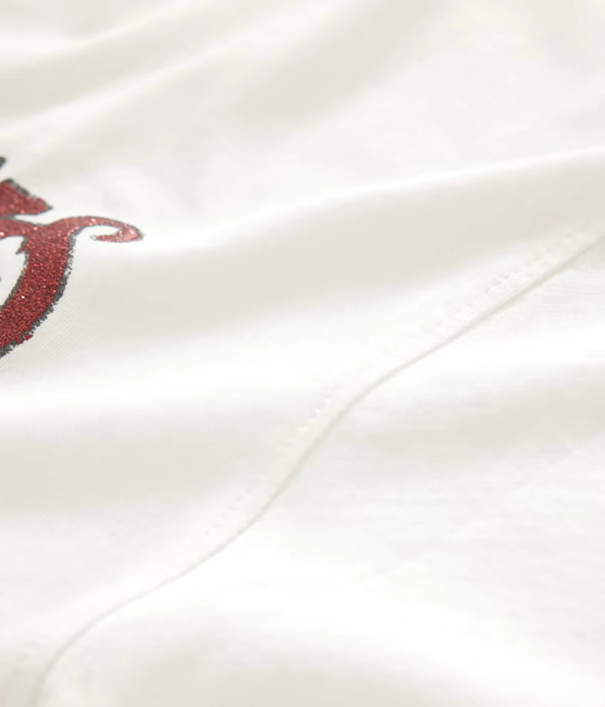 Close-up of John Varvatos The Rolling Stones NYC Raw Edge Tee in Salt showing the fabric, seam and red graphic detail