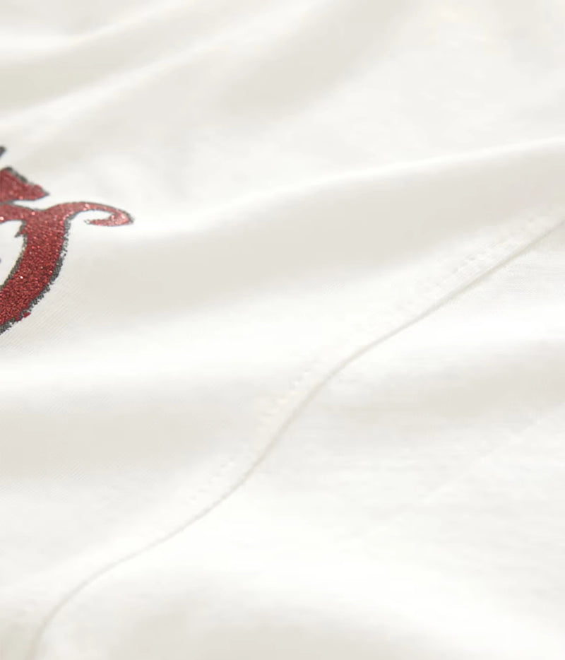Close-up of John Varvatos The Rolling Stones NYC Raw Edge Tee in Salt showing the fabric, seam and red graphic detail