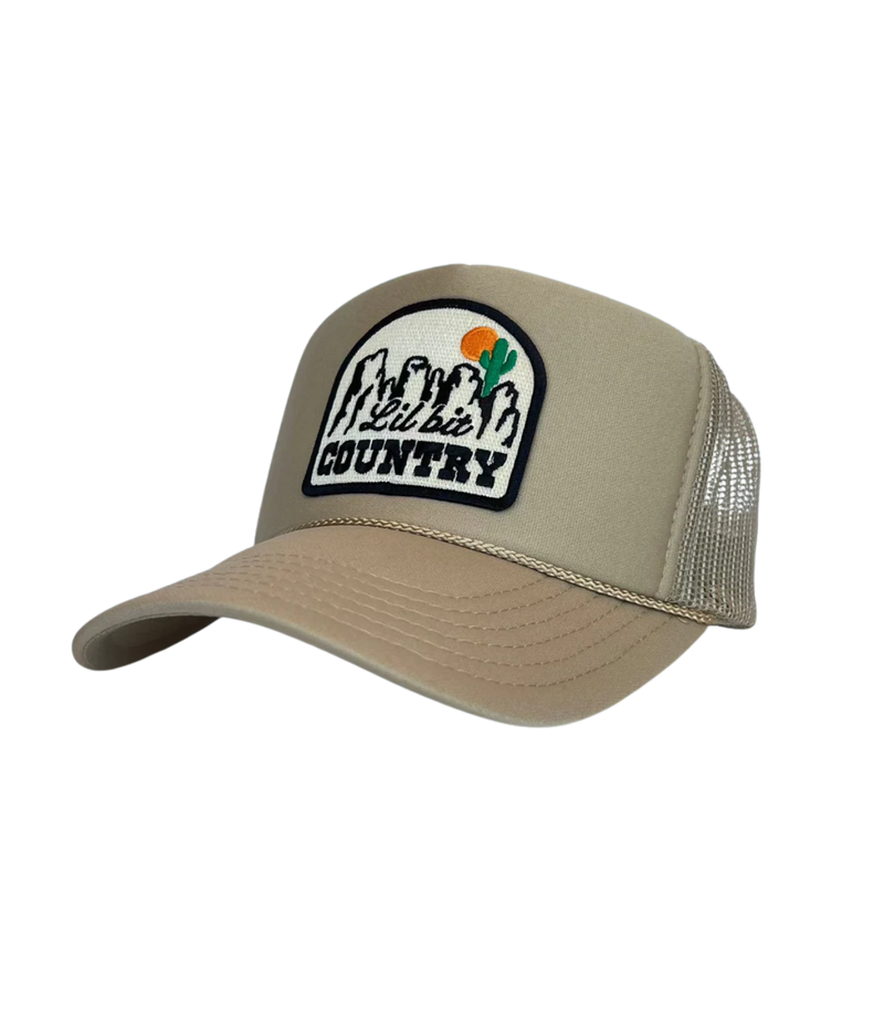 Port Sandz ‘Lil’ Bit Country’ high-profile trucker cap with foam front, mesh back, snapback closure, fully embroidered patch, playful western and country-inspired style