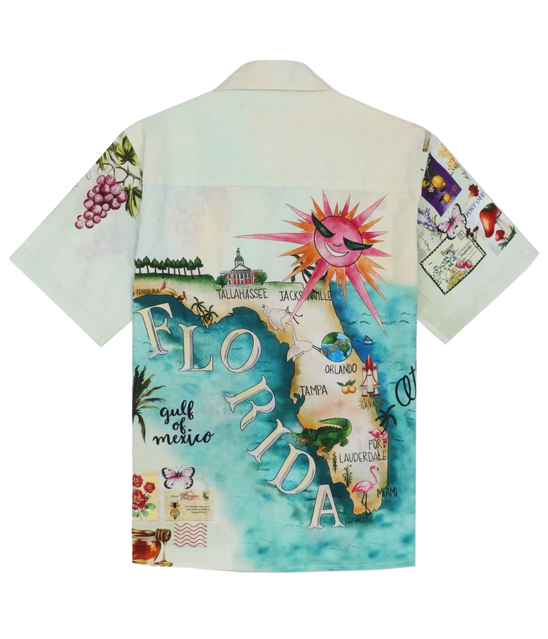 Perte D’ego Le Vacation Shirt with a Cuban collar, short sleeves, and a relaxed fit, crafted from a lightweight cotton-linen blend. Features a unique, vintage-inspired all-over print with Mother of Pearl buttons, designed for effortless summer styling.