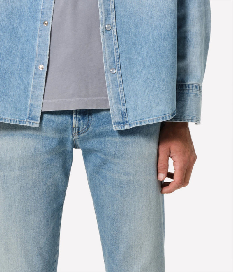 London Jean in Pavilion by Citizens of Humanity, featuring a slim fit through the hip and thigh with a tapered leg. Crafted from a stretch-enhanced fabric blend in a versatile mid-blue wash, these jeans offer a sleek, modern silhouette perfect for both casual and elevated looks.