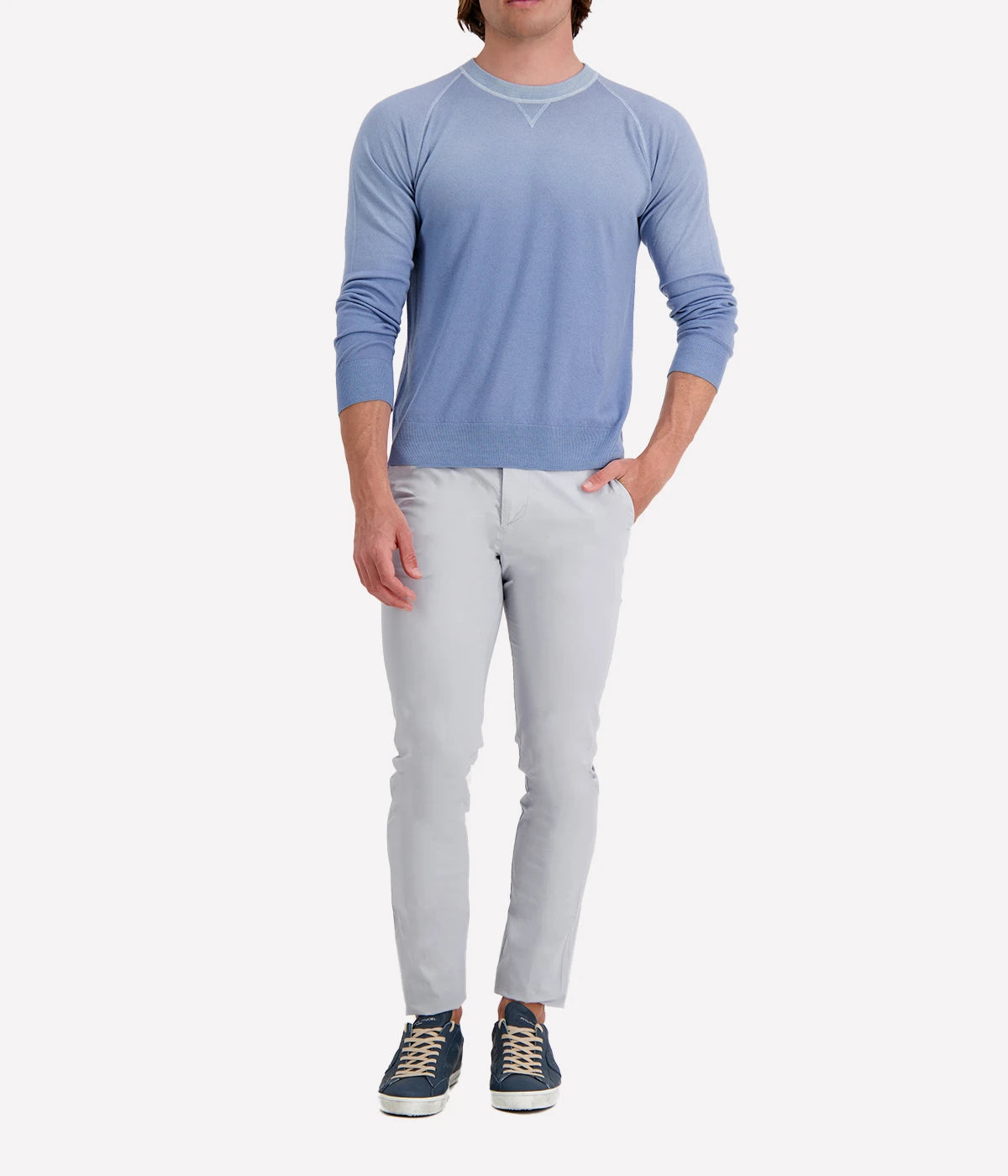 Model wearing the Eleventy sky blue crew neck sweater, styled with light trousers for a relaxed yet refined look.