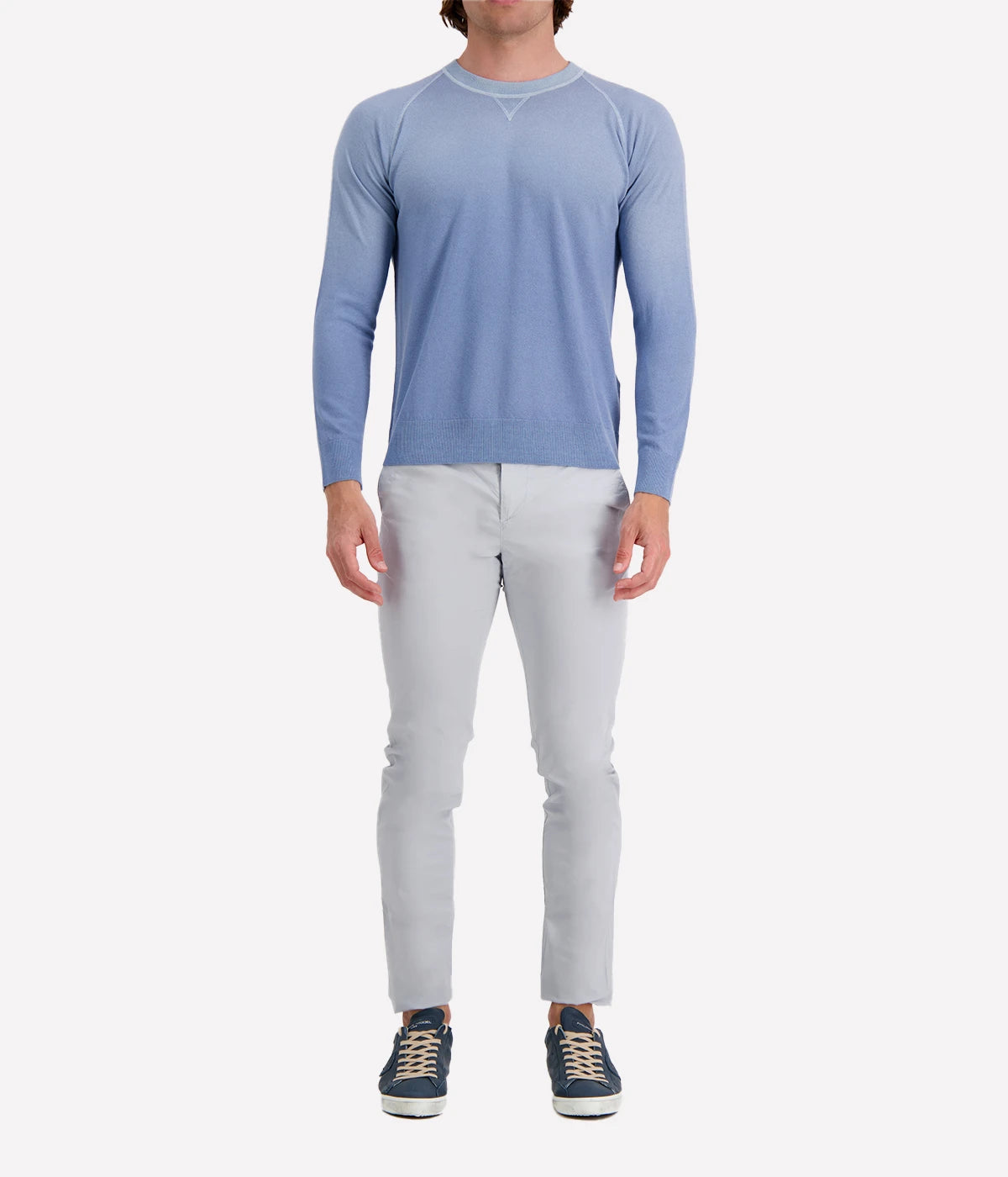Model wearing the Eleventy sky blue crew neck sweater, styled with light trousers for a relaxed yet refined look.