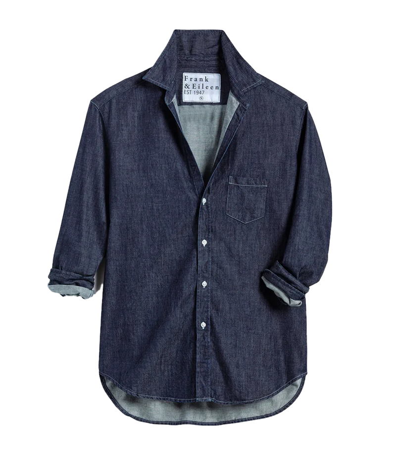 A flat lay of the Luke Raw Rinse Denim Shirt, highlighting its structured button-down design, classic collar, and deep indigo hue, showcasing the sleek, textured denim fabric in a clean and minimal layout.