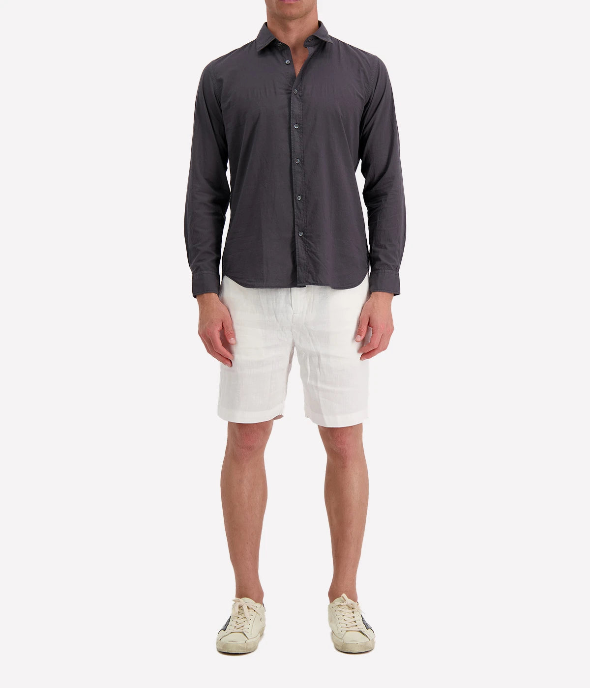 Model wearing the Hartford Sammy Shirt in lightweight cotton voile, featuring a pointed collar and buttoned cuffs. The slim fit creates a flattering, clean silhouette, perfect for casual summer styling.