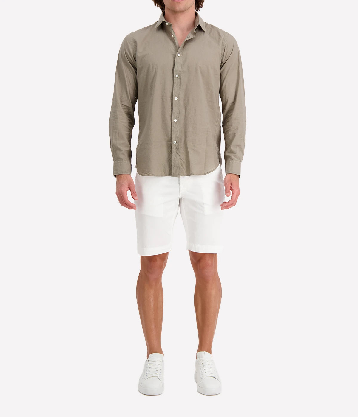 Model wearing the Hartford Sammy Shirt in lightweight cotton voile, featuring a pointed collar and buttoned cuffs. The slim fit creates a flattering, clean silhouette, perfect for casual summer styling.