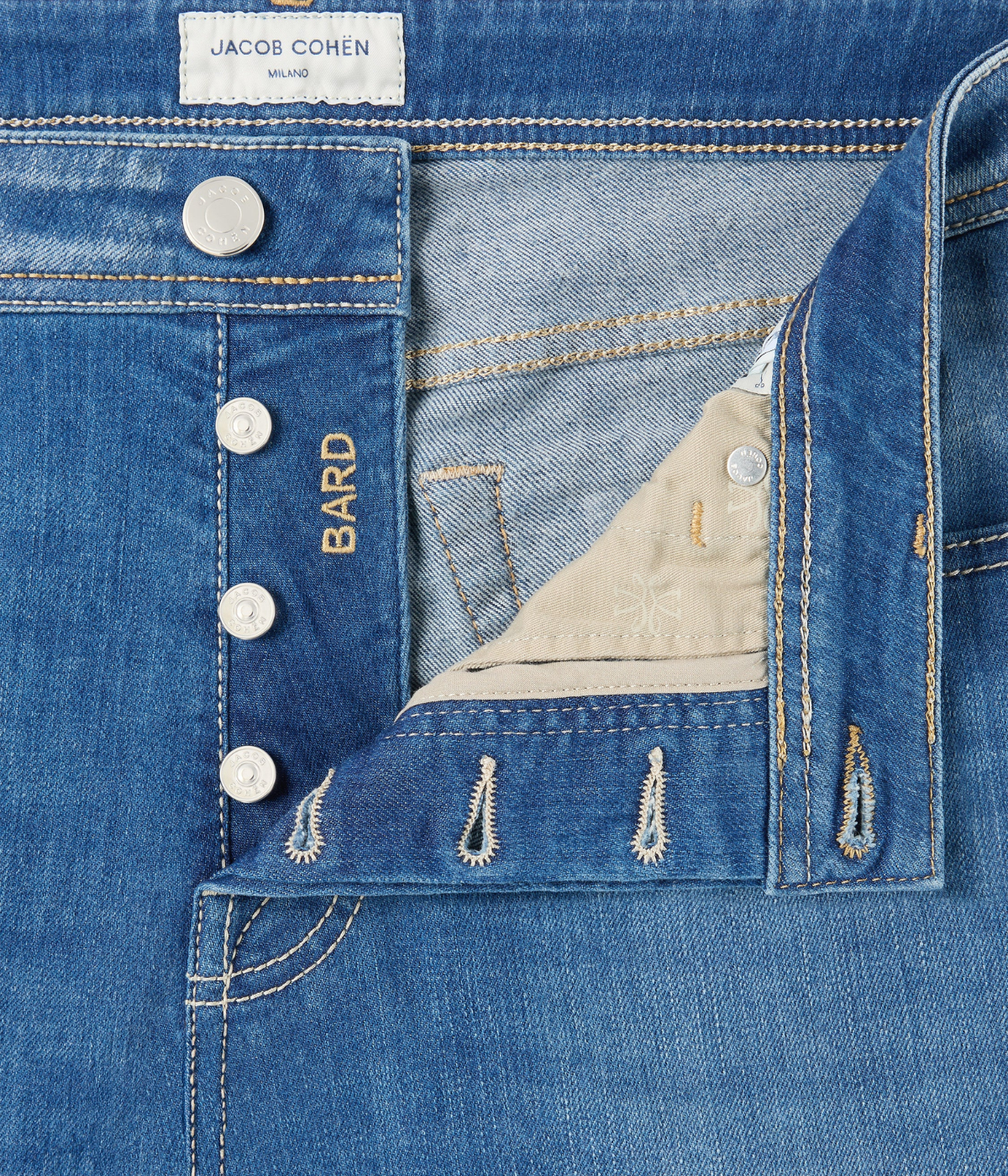 Jacob Cohën 5 PKT Slim Fit Bard Pant in Light Blue – close-up of button front fastening with embossed palladium-finish hardware detailing.