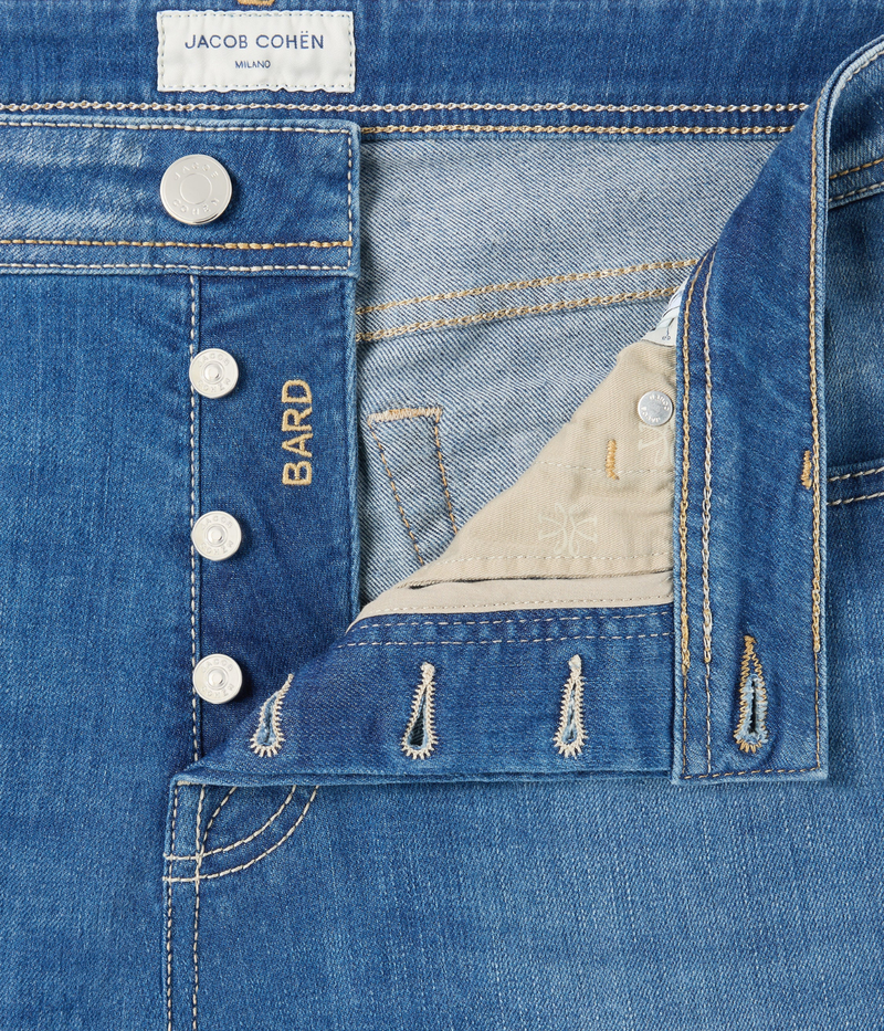 Jacob Cohën 5 PKT Slim Fit Bard Pant in Light Blue – close-up of button front fastening with embossed palladium-finish hardware detailing.
