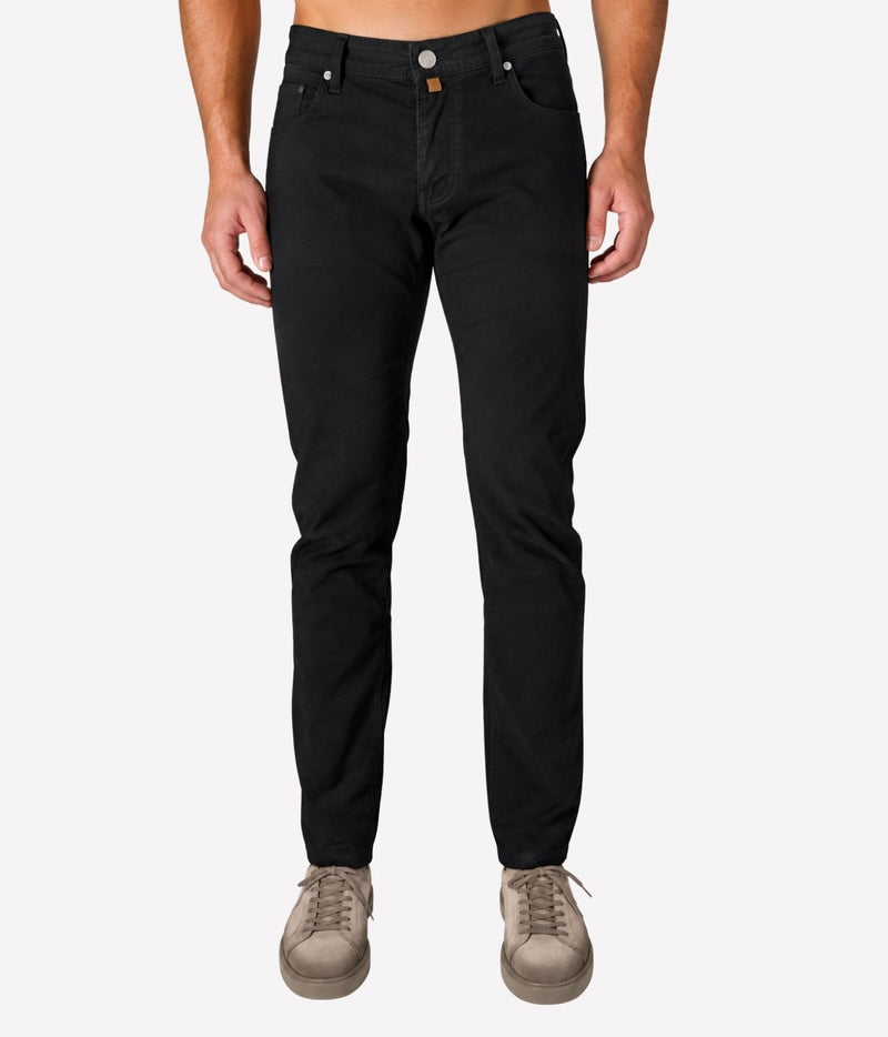 Man wearing Jacob Cohën Bard Regular-Slim 5 Pocket Pants in Black with a black top and grey suede shoes, front view