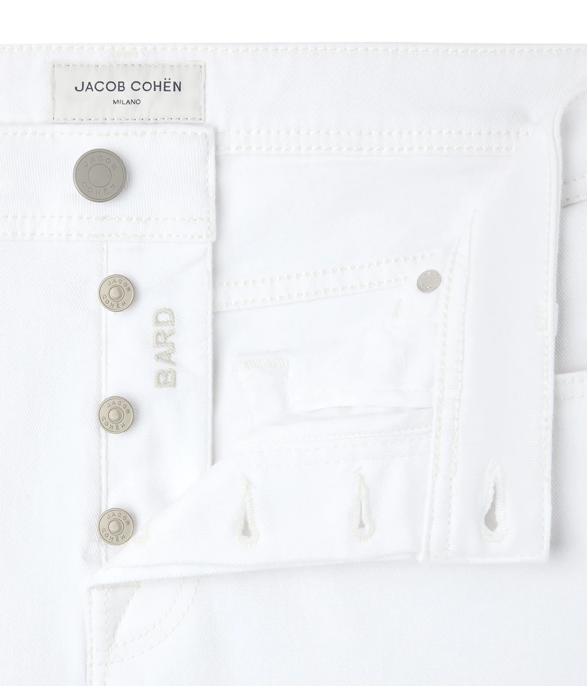 Close-up of Jacob Cohën Bard Slim Fit Pant in White showing the button fly and logo buttons