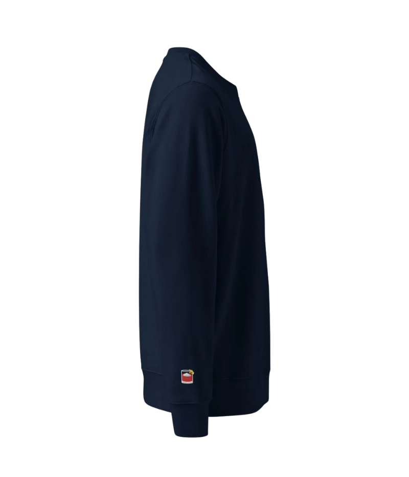 Navy unisex crewneck sweatshirt with "Negroni Please" graphic on chest and embroidered negroni icon on sleeve; features soft fleece lining and relaxed fit made from 100% organic cotton.