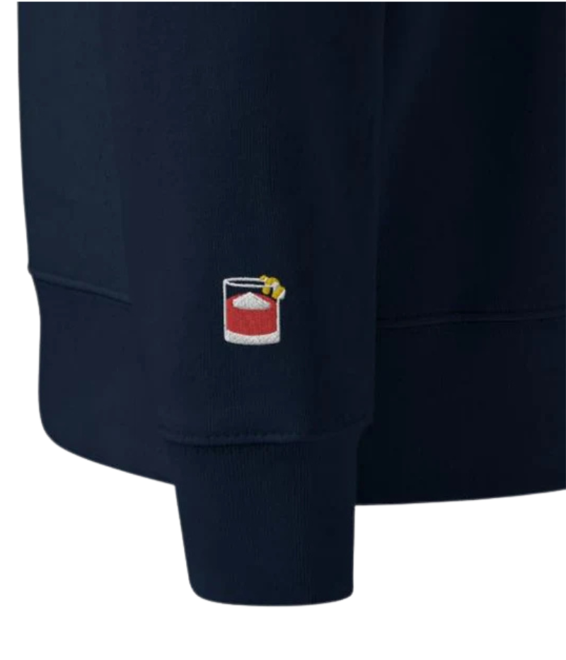 Navy unisex crewneck sweatshirt with "Negroni Please" graphic on chest and embroidered negroni icon on sleeve; features soft fleece lining and relaxed fit made from 100% organic cotton.