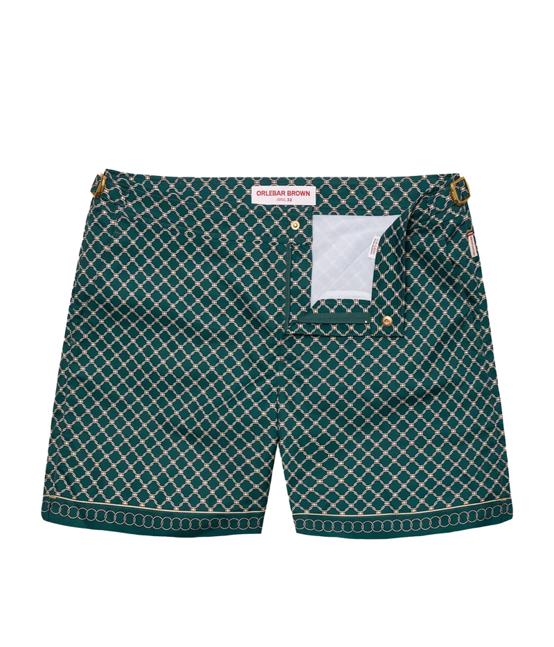 A pair of dark green and white patterned shorts with gold-tone hardware, displayed flat against a white background. The brand label 'CHIKULAK BROWN' is visible inside the waistband.