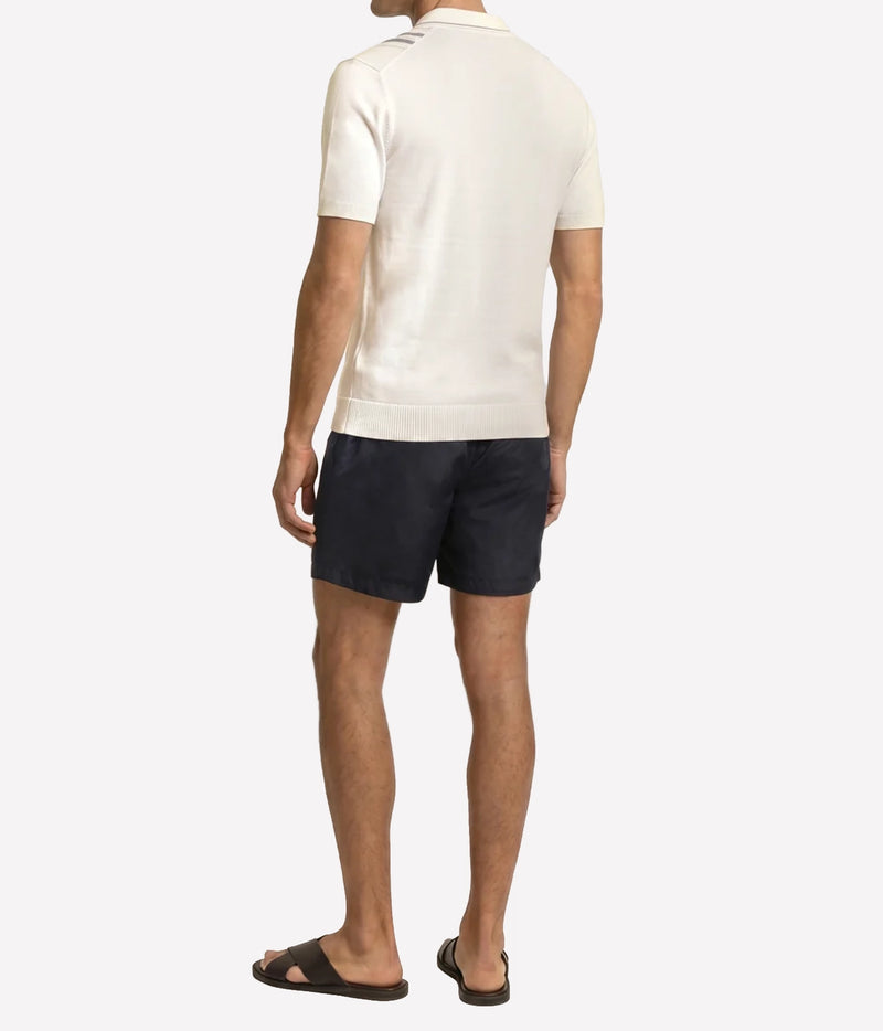 Man wearing Orlebar Brown Horton Chevron Stripe Polo in White Sand & Night Iris, back view