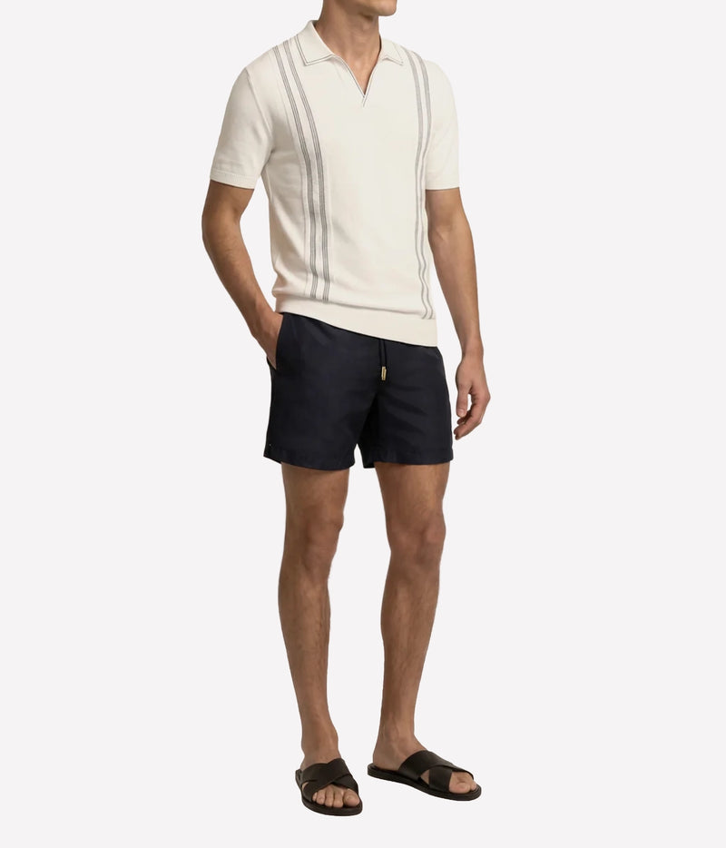 Man wearing Orlebar Brown Horton Chevron Stripe Polo in White Sand & Night Iris, front view