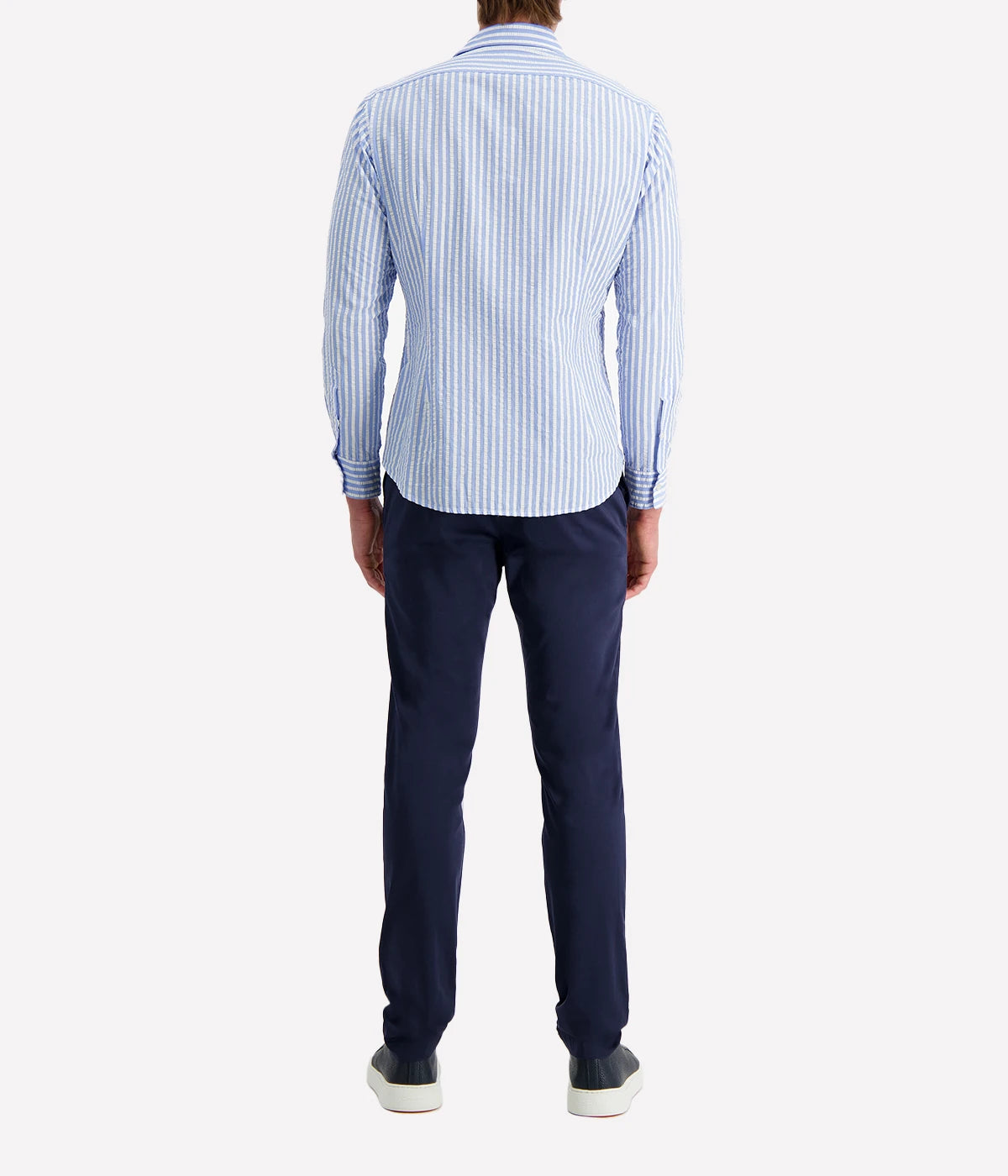 A men's slim-fit striped shirt by Ingram in lightweight blue and white cotton seersucker. Features a button-down front, a crisp collar, and long sleeves with buttoned cuffs. The breathable fabric has a subtle texture, perfect for a polished yet relaxed look.