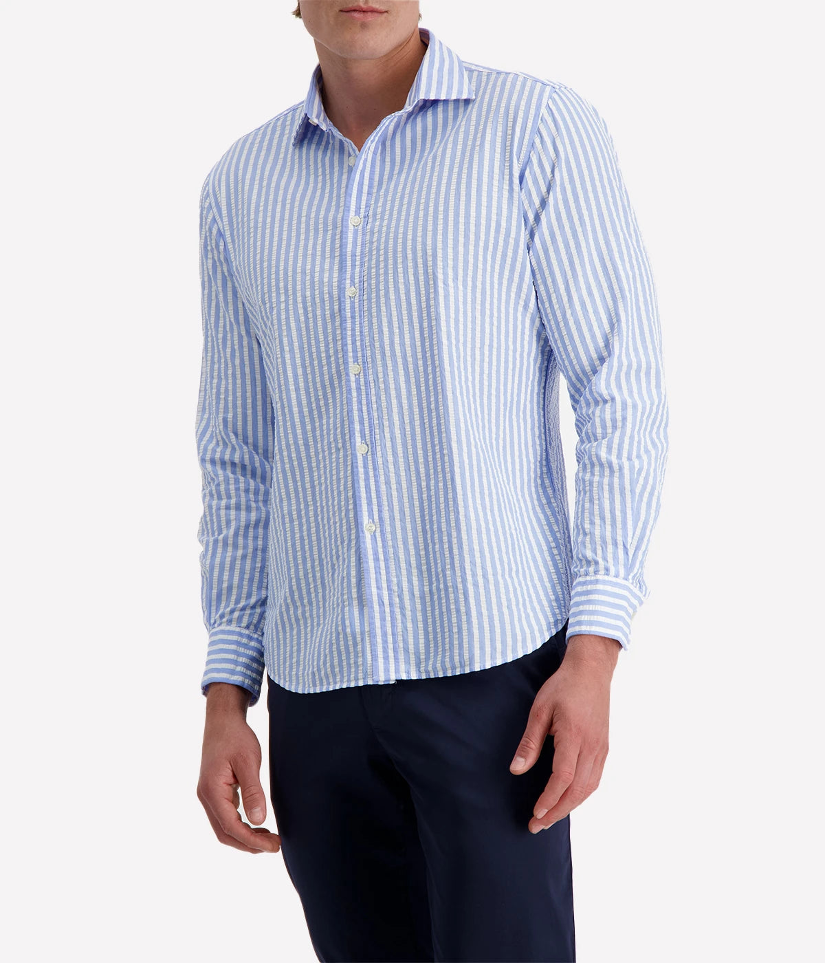A men's slim-fit striped shirt by Ingram in lightweight blue and white cotton seersucker. Features a button-down front, a crisp collar, and long sleeves with buttoned cuffs. The breathable fabric has a subtle texture, perfect for a polished yet relaxed look.