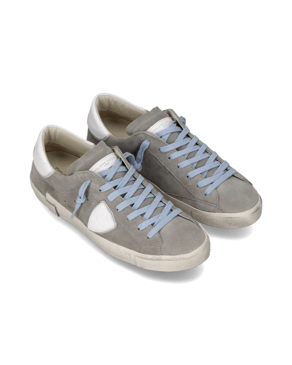 Pair of gray sneakers with light blue laces on a white background