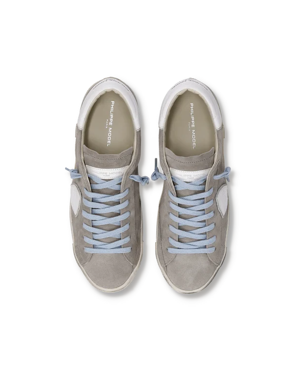 Pair of gray sneakers with light blue laces on a white background