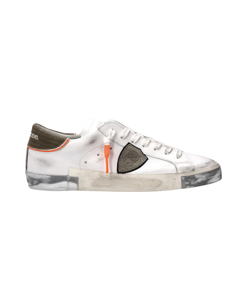Side angle of the PRSX sneakers, featuring green crocodile-print heel tab, contrasting piping, and handcrafted rubber sole with silver detailing.