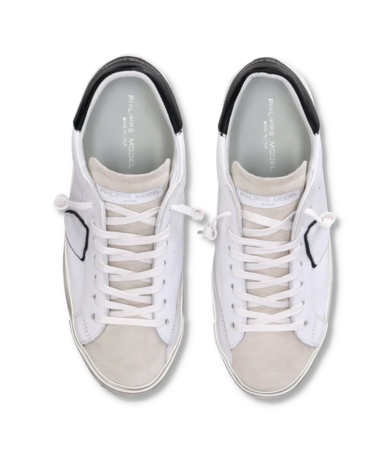Top view of Philippe Model PRSX Low Man sneakers, highlighting the worn-effect white screen-printed laces and the vintage-used effect on the calfskin and suede upper. The 2.5 cm high brushed rubber sole with a vintage effect is visible.
