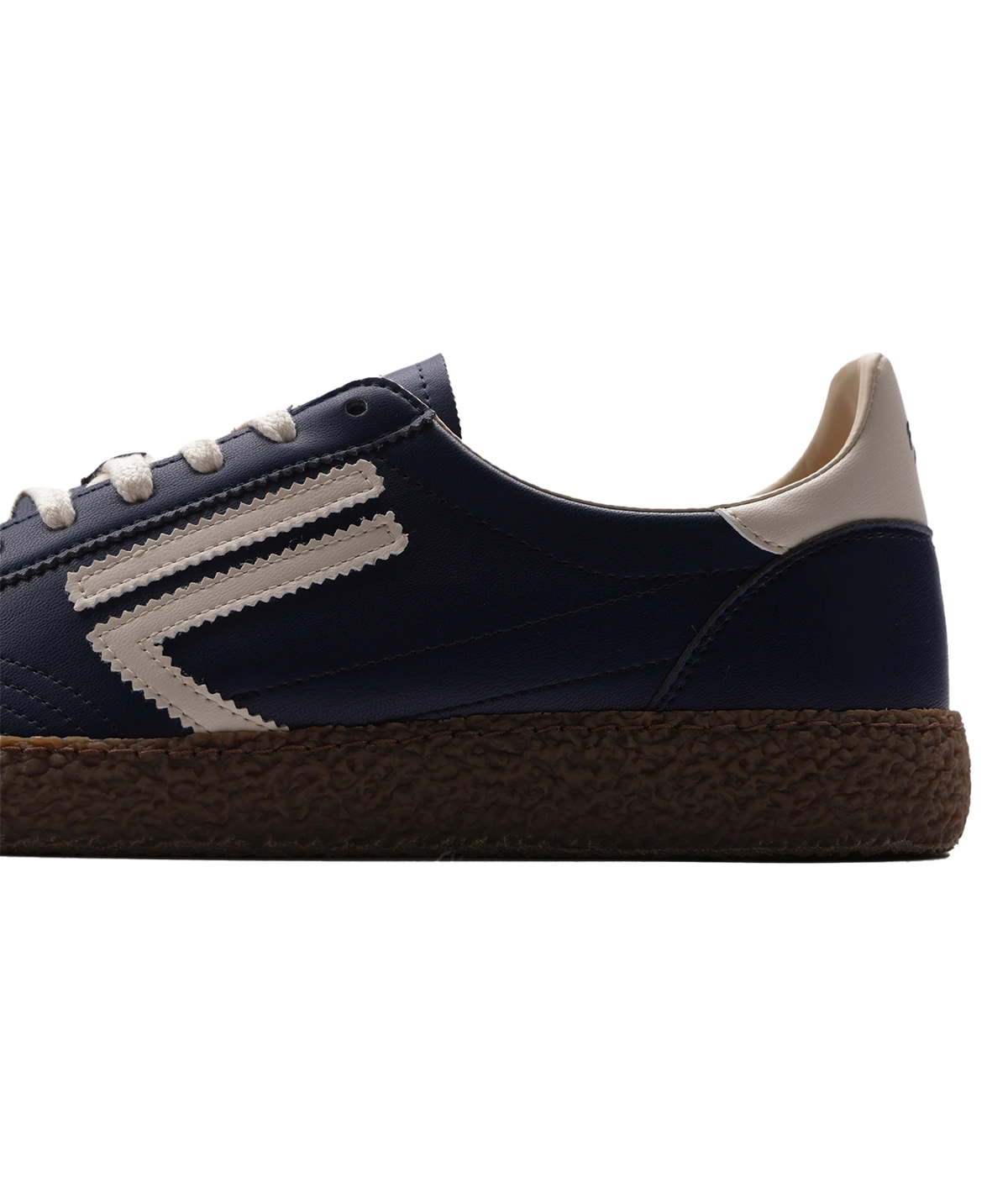 A navy blue sneaker with a textured brown sole, featuring cream-coloured laces, a cream heel tab, and a cream chevron stripe on the side.