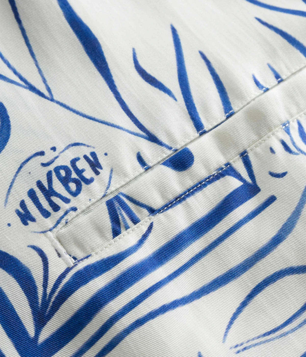 Short-sleeved vacation shirt in vibrant graphic pattern, crafted from breathable Tencel material. Features an open collar and relaxed fit, perfect for both casual and stylish outings. Made in Portugal