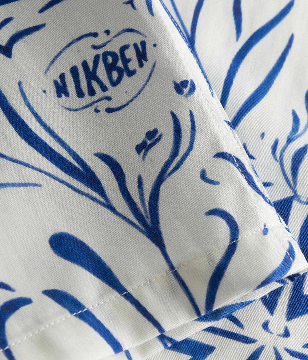 Short-sleeved vacation shirt in vibrant graphic pattern, crafted from breathable Tencel material. Features an open collar and relaxed fit, perfect for both casual and stylish outings. Made in Portugal