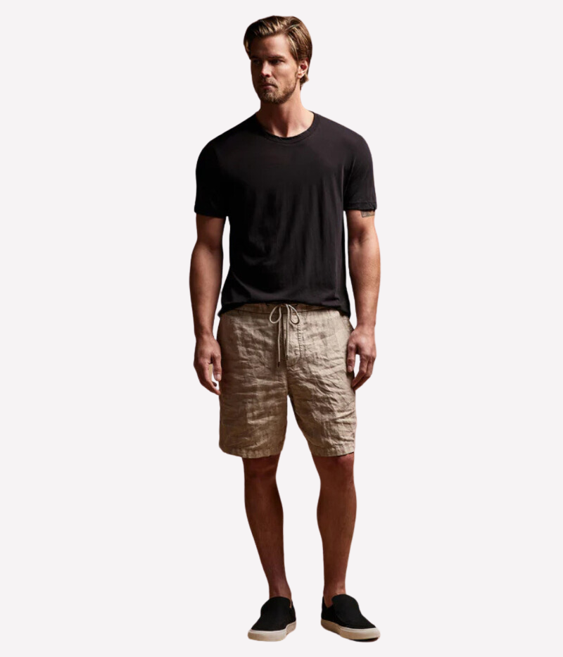 Model wearing the Relaxed Fit Linen Shorts with a fitted cotton tee and sneakers, perfect for a laid-back summer look. The textured linen fabric adds character to the outfit while keeping it comfortable and cool.