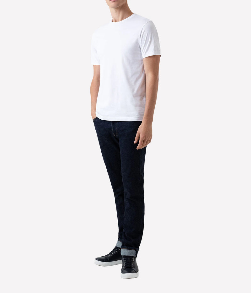 Model wearing the Sunspel Riviera T-Shirt, featuring a tailored fit and a classic crew neck. Made from luxurious midweight cotton, the shirt offers a smooth, durable feel and effortless style for any occasion.