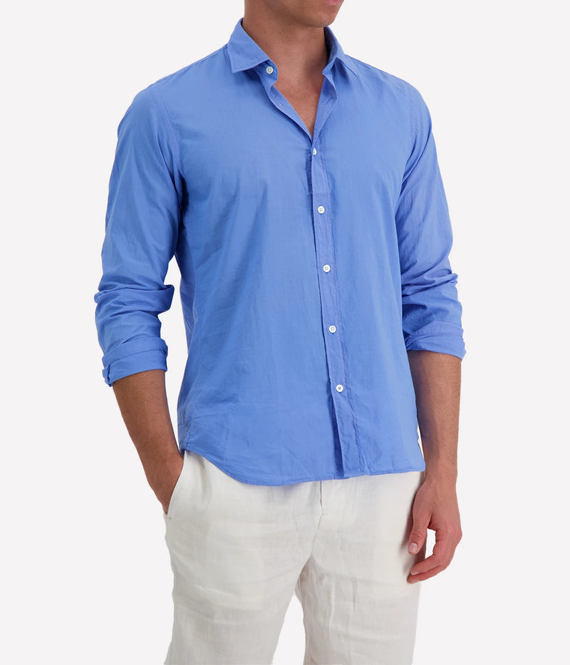 Model wearing the Hartford Sammy Shirt in lightweight cotton voile, featuring a pointed collar and buttoned cuffs. The slim fit creates a flattering, clean silhouette, perfect for casual summer styling.
