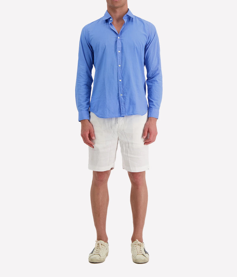 Model wearing the Hartford Sammy Shirt in lightweight cotton voile, featuring a pointed collar and buttoned cuffs. The slim fit creates a flattering, clean silhouette, perfect for casual summer styling.