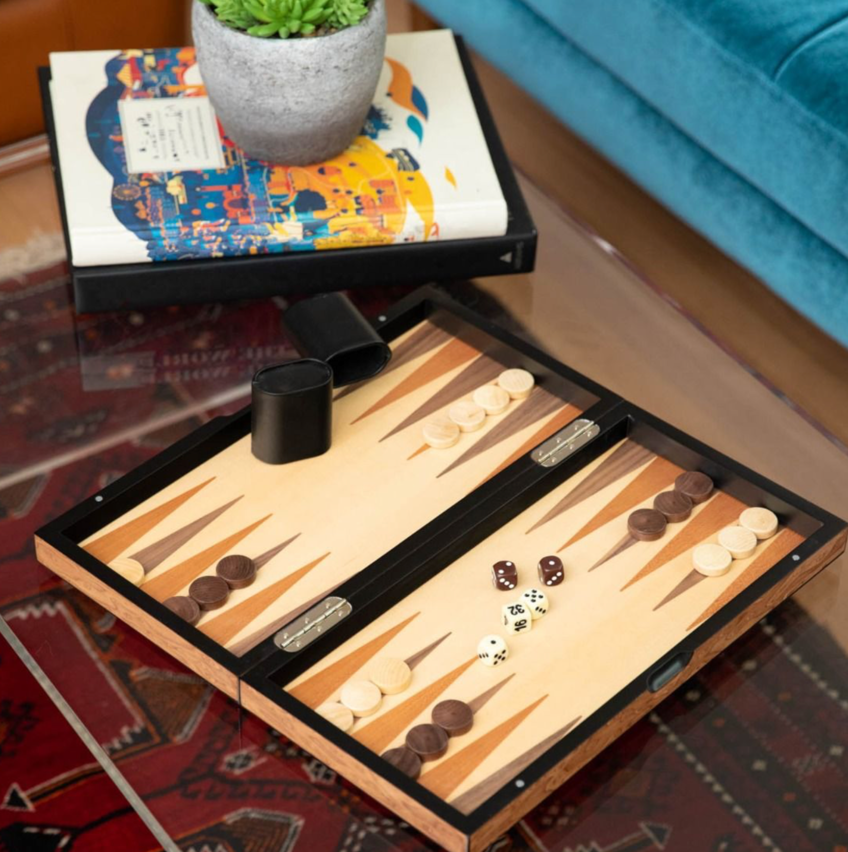 15.5" brown inlaid wood set, featuring a backgammon board on the inside and a chess and checkerboard on the outside. The set includes weighed pawns, wood checkers, dice, doubling dice, two dice cups, and a magnetic closure, blending elegance with functionality.