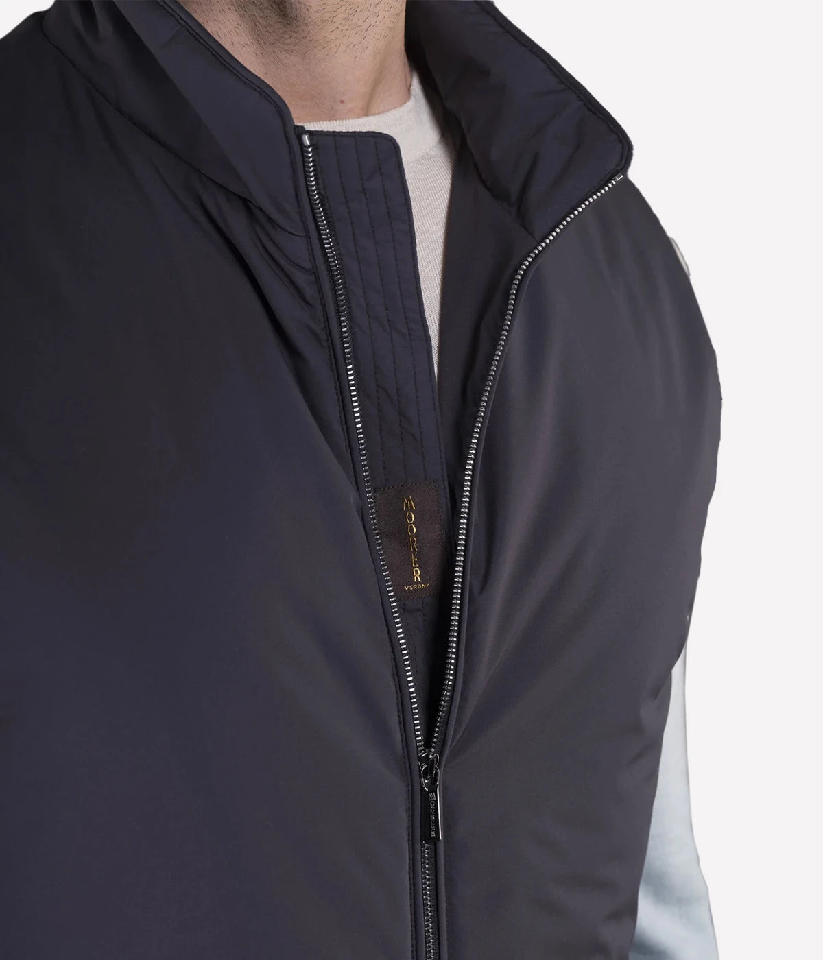 Senio Vest in Navy by MooRER, featuring water-repellent lightweight fabric, synthetic feather-effect padding, double-zip front closure, and zippered pockets. Made in Italy.