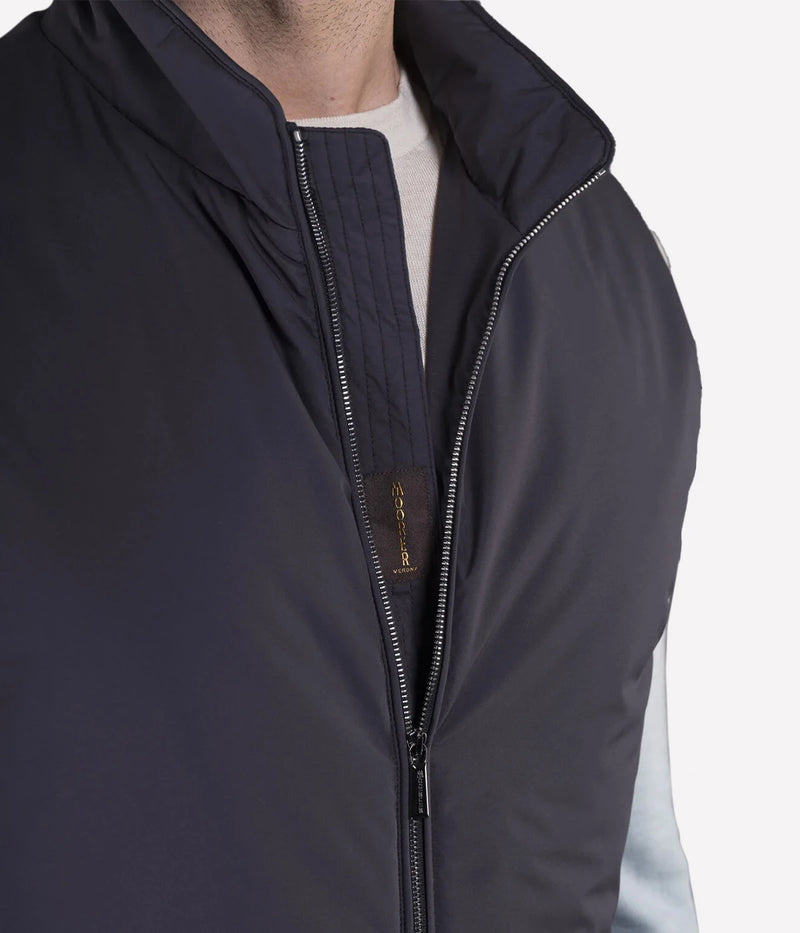 Senio Vest in Navy by MooRER, featuring water-repellent lightweight fabric, synthetic feather-effect padding, double-zip front closure, and zippered pockets. Made in Italy.