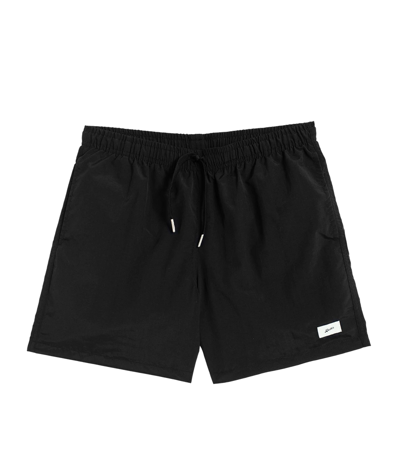 Front view of Bather solid swim trunks, featuring a 5.5-inch inseam and an elasticized waist for a secure and comfortable fit. Made from 100% recycled quick-dry polyester, the trunks are designed with reinforced side pockets and a back pocket with a snap closure.