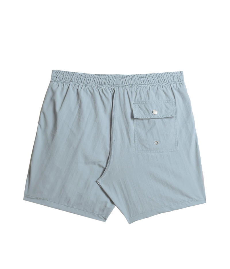 Back view of Bather solid swim trunks, showing the snap-closure back pocket and clean, tailored design. The ultra-fine mesh liner provides quick-dry functionality and four-way stretch for enhanced comfort.
